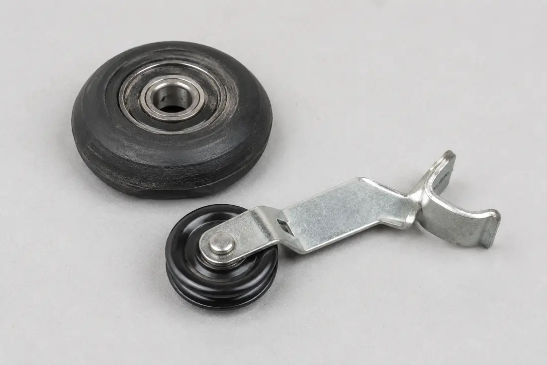 Worn dryer drum support roller and idler pulley
