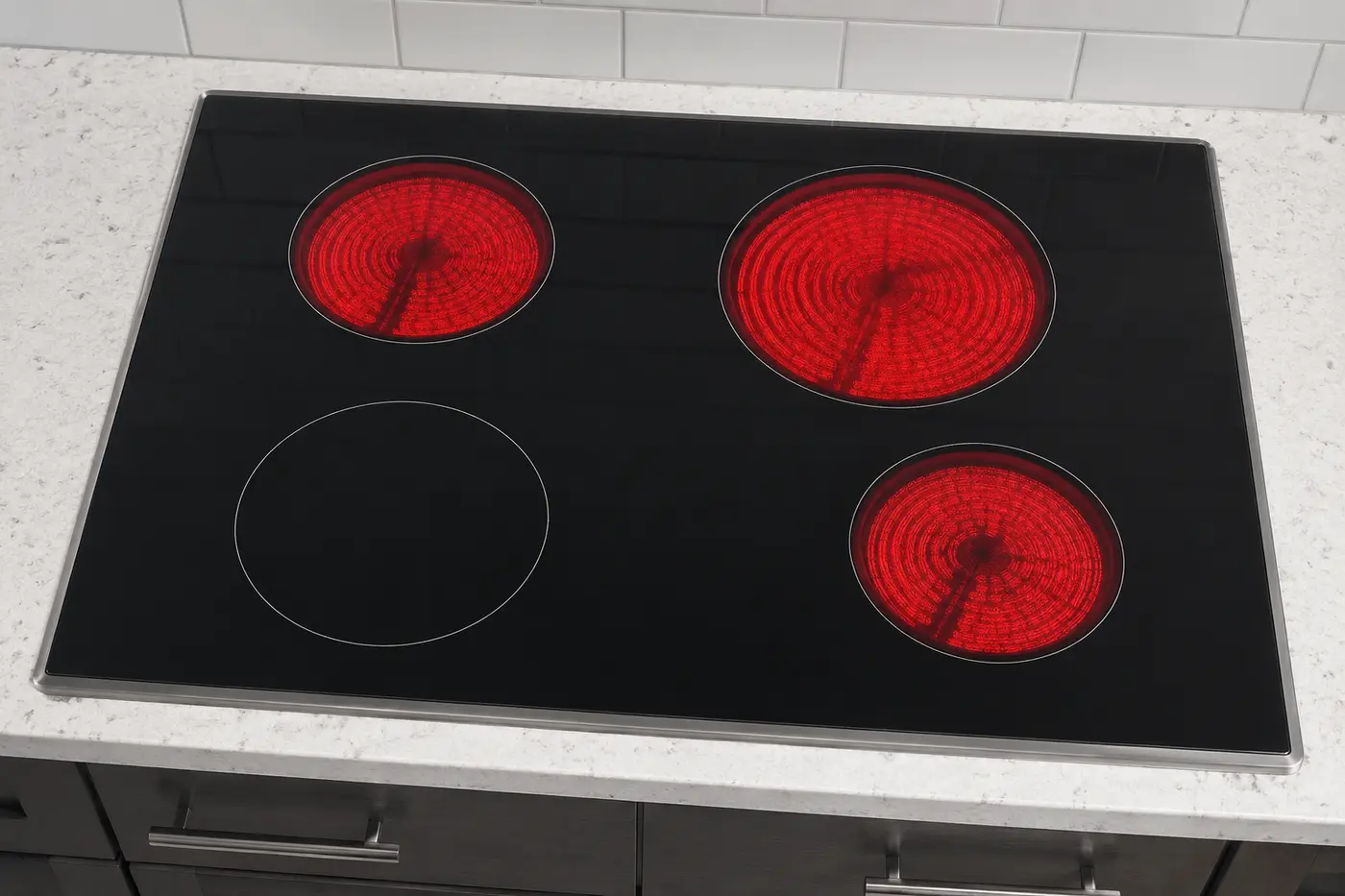 Black glass cooktop with one radiant element remaining dark while the others heat