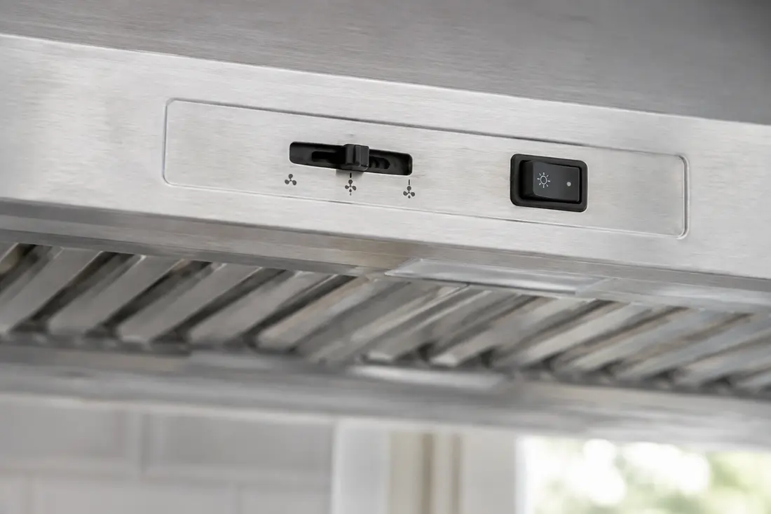 Three-speed slide switch on a stainless range hood control panel