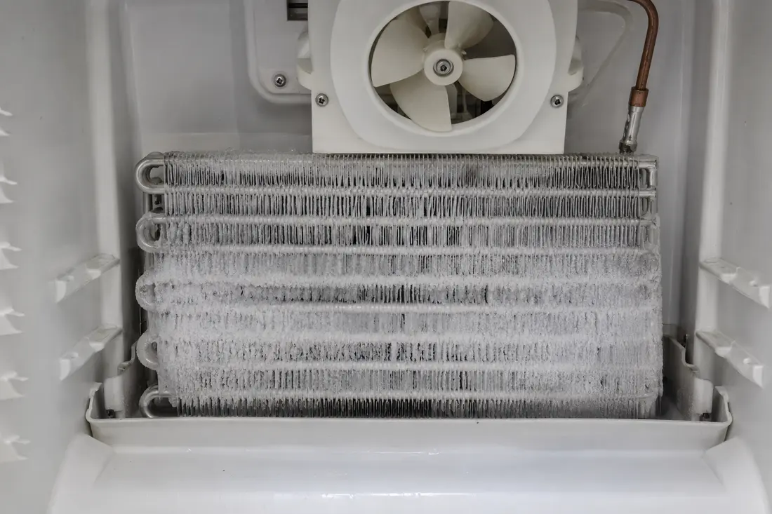 Refrigerator evaporator coil covered with heavy frost